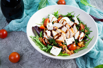 Fresh salad with chicken, tomatoes, herbs and feta cheese. Healthy food