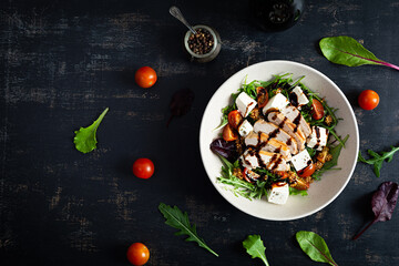 Fresh salad with chicken, tomatoes, herbs and feta cheese. Healthy food. Top view