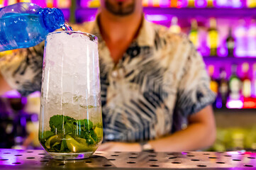 bartender preparing mojito cocktail drink in bar