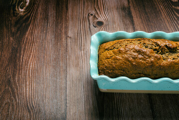 Pound cake in blue mold on wooden table. Homemade banana pound cake.