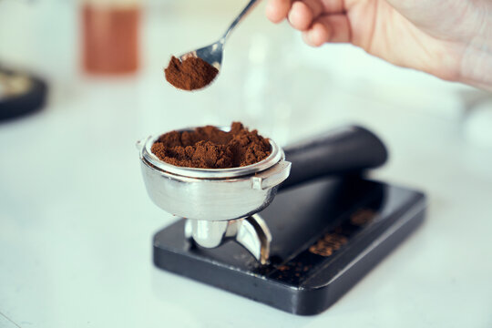 Freshly ground espresso getting measured out on a scale.