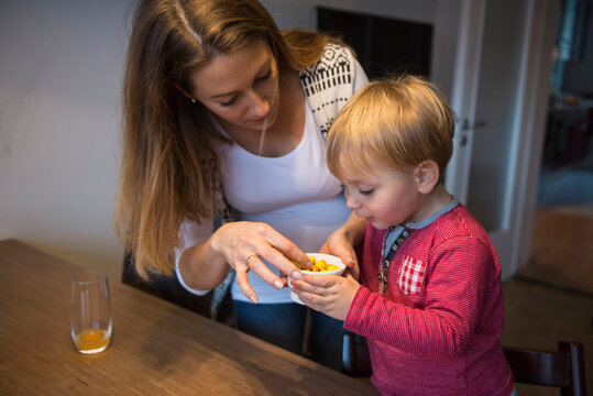 Mother offering candies to her little son, Munich, Germany