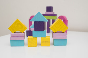 wooden multi-colored blocks on a white table. Educational games for toddlers and children. development of motor skills in children, environmentally friendly children's toys