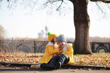 Children walk in the autumn park