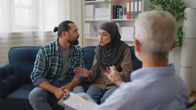 Muslim couple arguing while visiting psychologist, family counselor, crisis