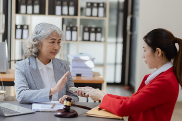 lawyer working with contract agreement at table office, lawyer holding money and justice concept, Selective focus.