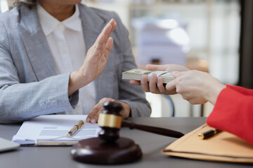 lawyer working with contract agreement at table office, lawyer holding money and justice concept, Selective focus.