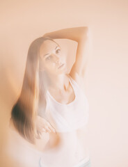 Graceful adult woman posing in white t-shirt.