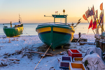 Winter on Baltic Sea in Gdynia, Poland:Colorful fishing boats on the beach in Orlowo