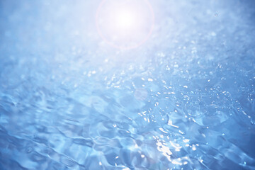 Bubbles and seething water in the light of sunlight.Blue water texture.