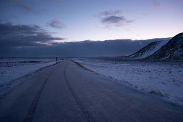 Iceland winter landscape road after sunset in Múlaþing 