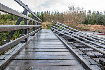 Obraz premium An old, rotten wooden bridge over the Owenea river by Ardara in County Donegal - Ireland