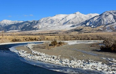 scenic winter landscape on a sunny day  at mallard's rest fishing access along the paradise valley scenic loop of the yellowstone river and gallatin range, south of livingston, montana