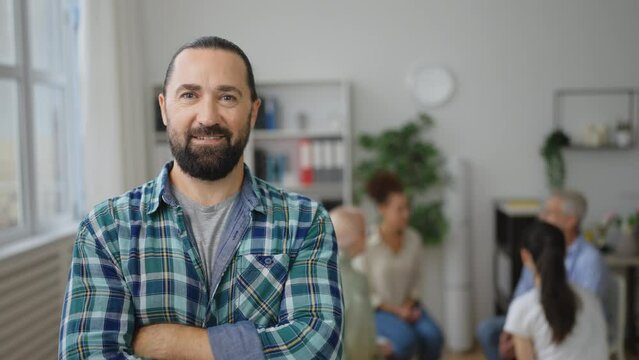 Portrait of middle-aged man feeling better after getting help in support group