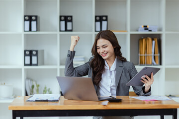 Young woman celebrate with laptop, success happy pose, Successful business results in modern office with joy concept. 
