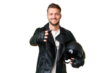 Young caucasian man with a motorcycle helmet over isolated chroma key background shaking hands for closing a good deal