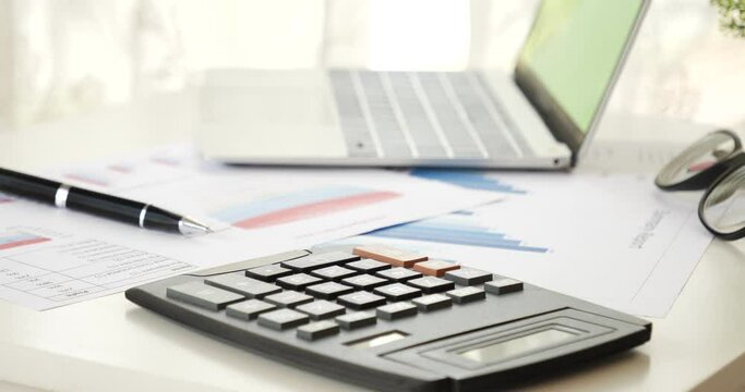 Office laptop business financial document chart and graph on wooden table with coffee cup. Flat lay notebook computer laptop on office desk. No people business graph chart mockup on business workspace