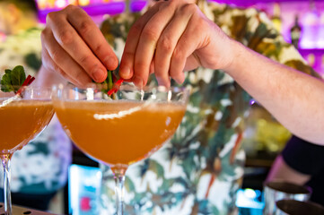 man hand bartender making cocktail in glass on the bar counter