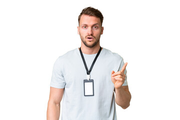 Young caucasian man with ID card over isolated chroma key background intending to realizes the solution while lifting a finger up