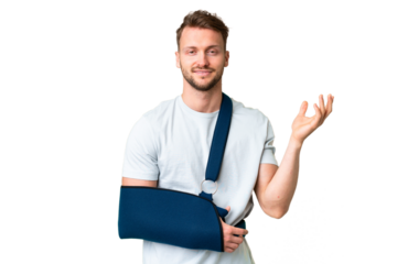 Young caucasian man with broken arm and wearing a sling over isolated chroma key background extending hands to the side for inviting to come