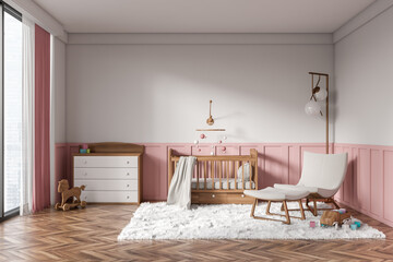 Front view on bright baby room with child bed, armchair