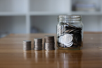 stack of silver coins, saving money for financial investment concept.

