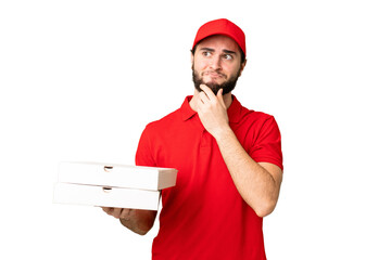 pizza delivery man with work uniform picking up pizza boxes over isolated chroma key background having doubts and thinking