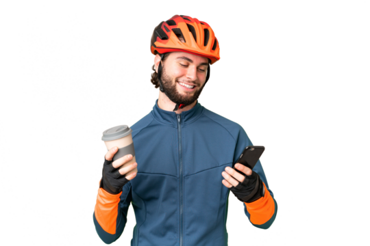 Young cyclist man over isolated chroma key background holding coffee to take away and a mobile