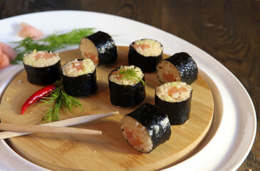 Sushi Set - Different Types of Maki Sushi and Nigiri Sushi. Served on dark wooden table.