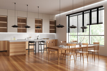 Light kitchen interior with bar countertop and eating area near panoramic window