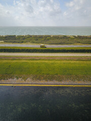 Campervan Parked By the Sea in the Netherlands from above, drone shot
