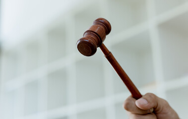 lawyer hand holding Hammer, Law theme.