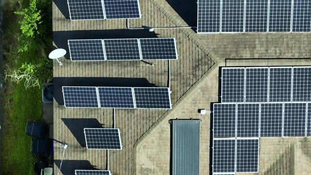 Aerial view of typical american building roof with rows of blue solar photovoltaic panels for producing clean ecological electric energy. Renewable electricity with zero emission concept