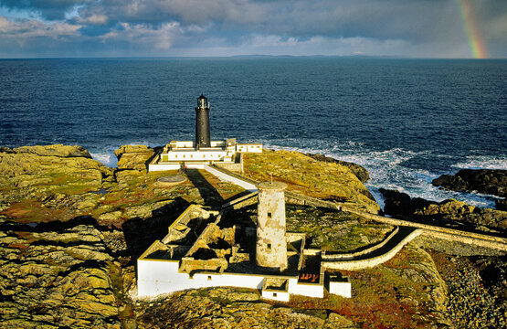 Slyne Head old white and new black lighthouses mark treacherous rocky islands at southwest tip of Connemara, County Galway, Ireland. Aerial
