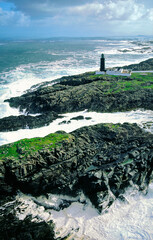 Stormy Atlantic weather. Slyne Head lighthouse marks the treacherous rocks of at southwest tip of Connemara, County Galway, Ireland. Aerial