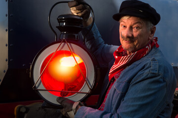 Vintage machinist with old locomotive lamp