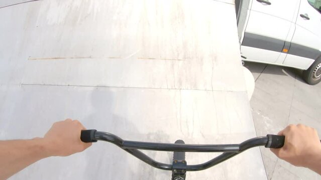 POV boy doing amazing stunts with bicycle