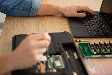 Obraz na płótnie Canvas an engineer performing laptop maintenance