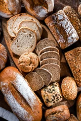 Fotobehang Assorted bakery products including loafs of bread and rolls © monticellllo