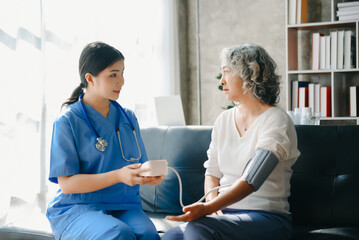 Obraz premium Asian female hands touching old female hand Helping hands take care of the elderly concept