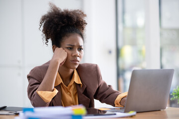 Young African American businesswoman working with pile of documents at office workplace,  feeling sick at work, stress from work, overworked, problem, unhappy.	