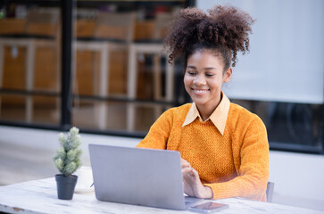 Young African American businesswoman working with pile of documents at office workplace, business finance and accounting concepts.