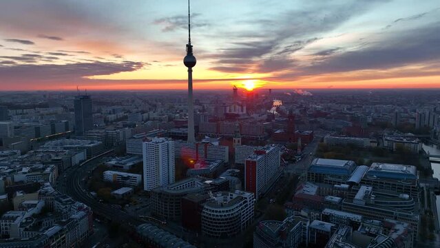 City of Berlin, Germany from above. Aerial cityscape view showing architectural landmarks Reichstag, TV Tower and Berlin Cathedral at sunrise. Drone flight to Alexanderplatz TV Tower, Sunset