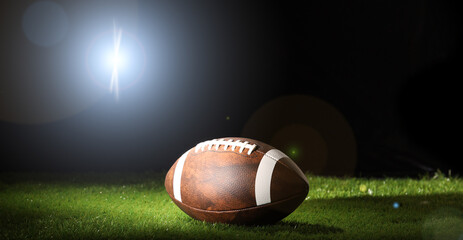 Ball for American football on a sports graund. USA game. Copy space.