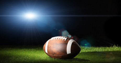 Ball for American football on a sports graund. USA game. Copy space.