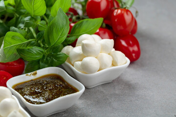Mozzarella cheese with basil, pesto sauce, and tomatoes.
