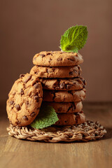Chocolate cookies with mint on a wooden table.