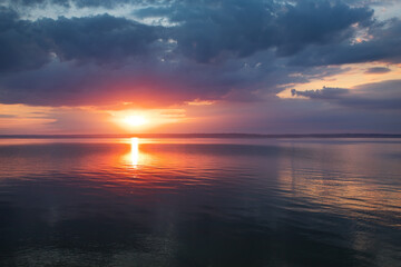 Dramatic sunset above a water. Beautiful landscape.