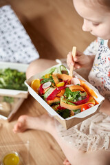Healthy salad of broccoli, green peas, cucumber and avocado and olive oil. Healthy food. Top view, copy space.