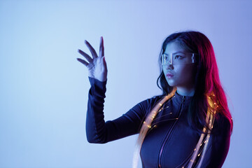 Woman in futuristic costume. Female in modern VR glasses interacting with network while having...
